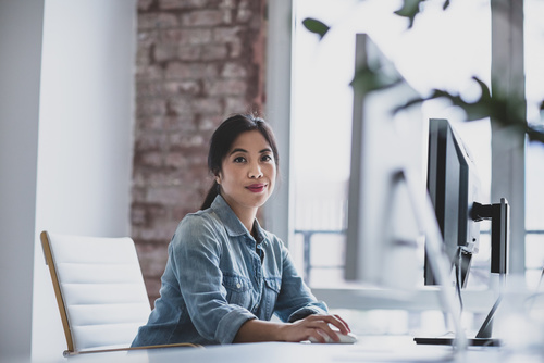 Portrait of a young adult female executive working in an office